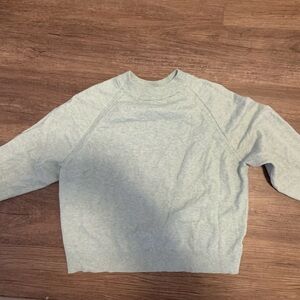 I know in the picture it’s grey but it’s a light green/teal sweater.